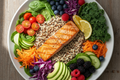 Platter of salmon with various vegetables on a wooden surface