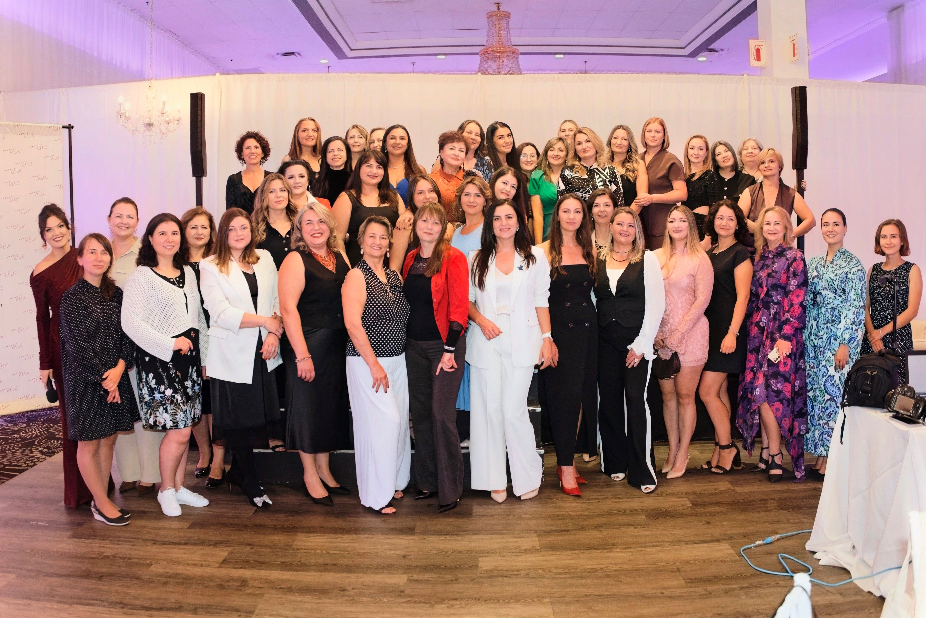 Group of women posing for a photo in a formal setting